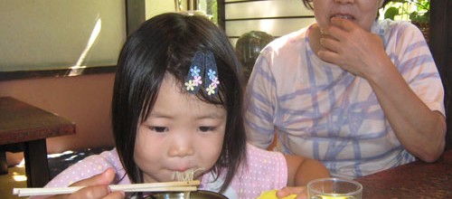 Little girl eating soba 